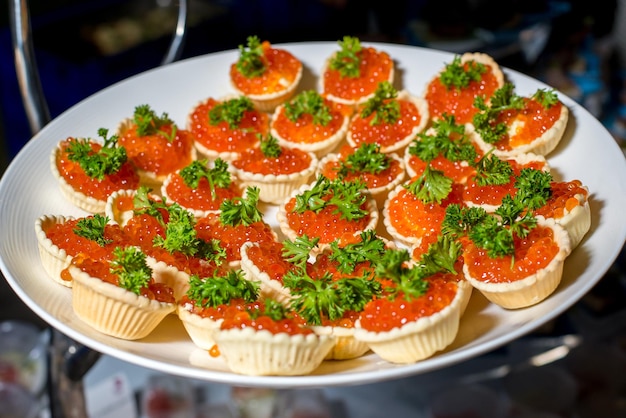 Small canapes appetizer with red caviar