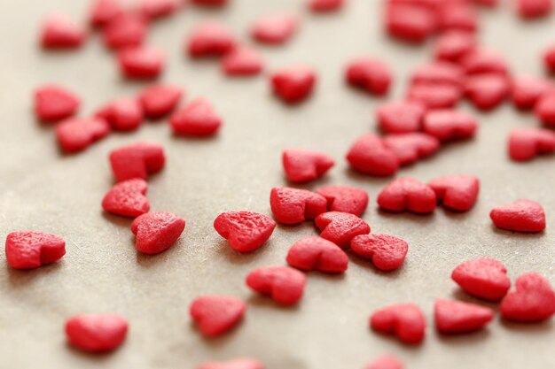 Small candy hearts on paper background