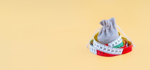 A small canvas bag wrapping with a centimetre on a yellow background