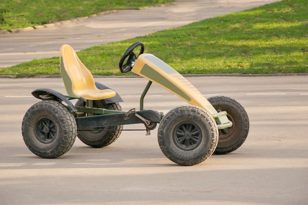 Small car with pair of pedals and chain on gears