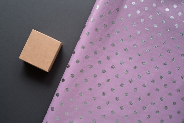 Photo small cardboard box and lilac polka dot wrapping paper.