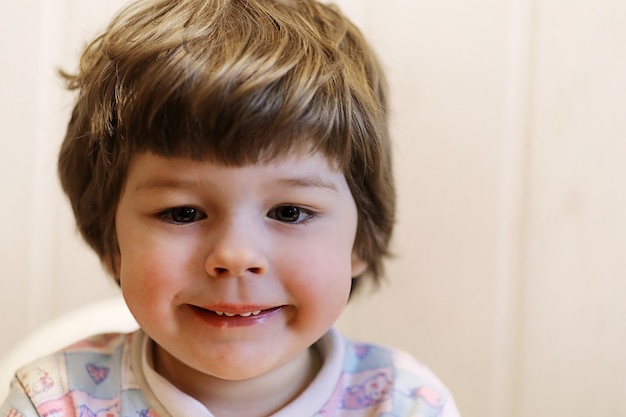 Small caucasian kid smiling and have fun white background