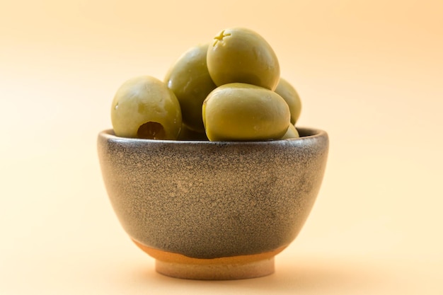 Small ceramic bowl with olives of the gordal type typical appetizer in the Mediterranean