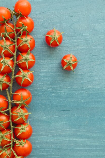 Small cherry tomatoes on a blue wooden table