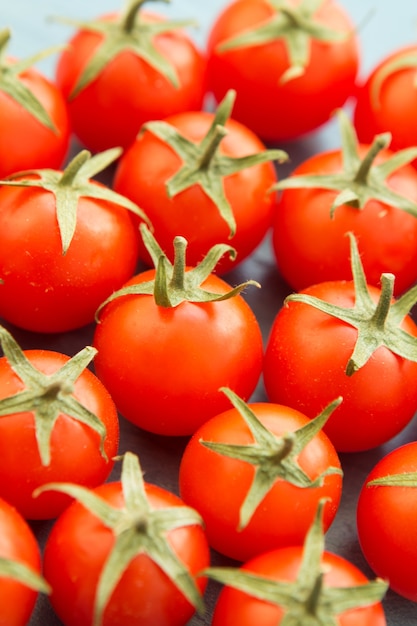 Small cherry tomatoes on a blue wooden table