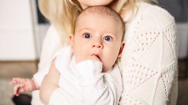 A small child in the arms of mom  positive human emotions feelings