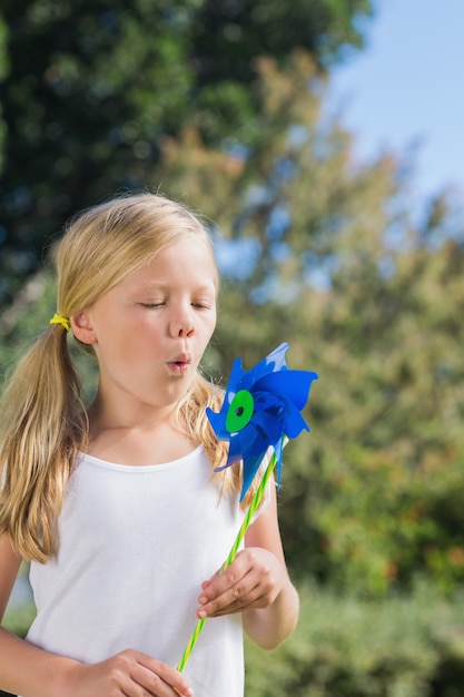 Small child blowing the pinwheel