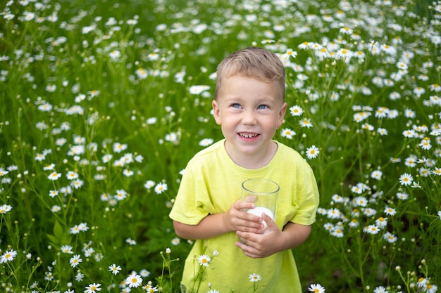 a small child a boy in clothes made of natural cotton walks around the field