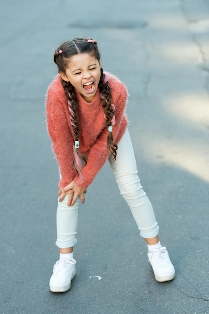 Small child has pain in knee shouting little girl in autumn sweater Autumn snuggles Autumn fashion for pretty girl healthy childhood leg injury of little girl Pure feelings Melancholic mood