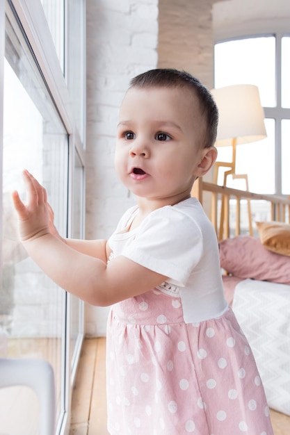 A small child looks out the window and is surprised Positive emotions