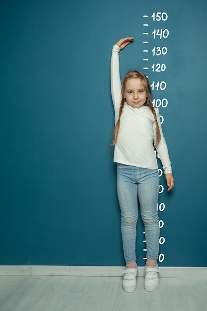 small child math student writing science formulas on blue background
