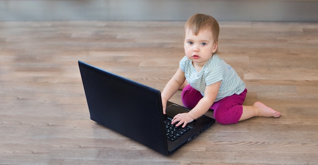 Small child plays on computer.