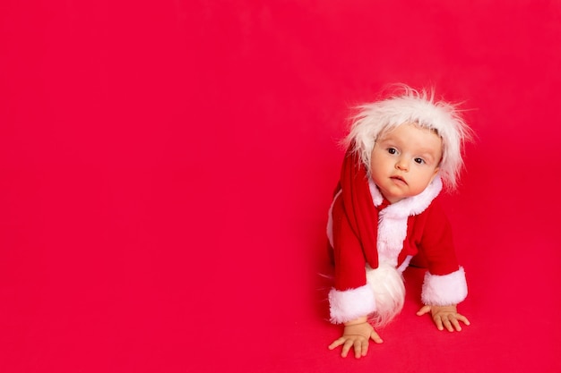 Small child in a Santa costume crawls