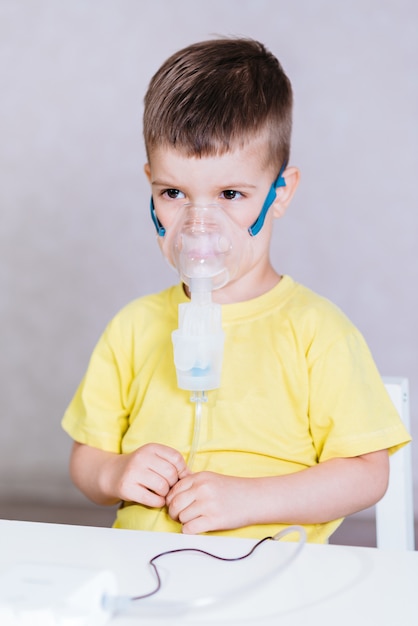 Small child treats bronchitis inhaler at home