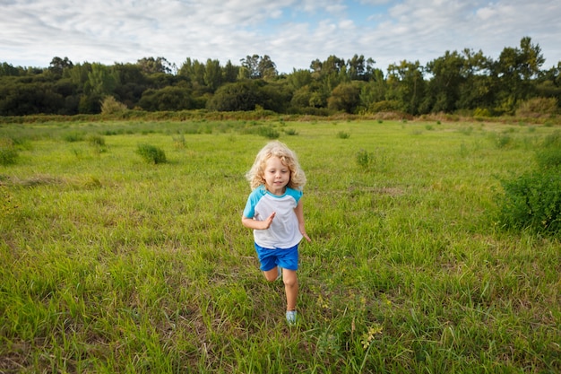 Small child with long blond hair enjoying 