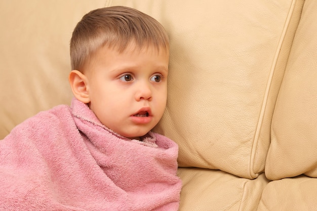 Small child wrapped in a towel after bathing
