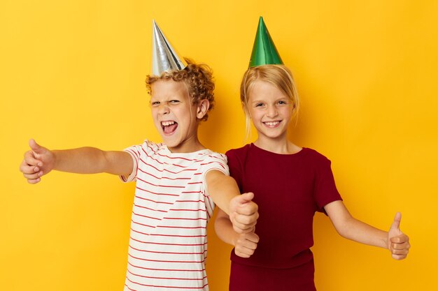 Small children holiday fun with caps on your head yellow background