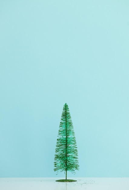 Small christmas tree on blue background