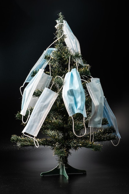 Small christmas tree decorated by protective masks