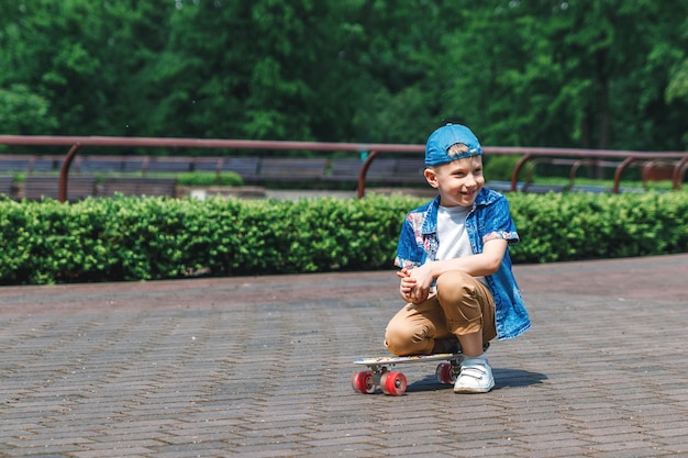 A small city boy andskateboard. A young guy is riding in a parka skateboard