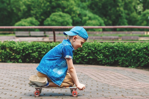 A small city boy andskateboard. A young guy is riding in a parka skateboard