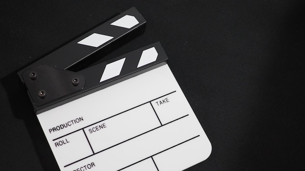 Small Clapper board or movie slate use in video production ,film and cinema industry. It's put on white background.