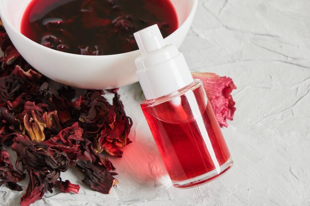 Small clear spray bottle with hibiscus petal tonic