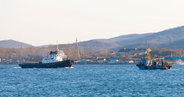 Small commercial net fishing boat and tugboat