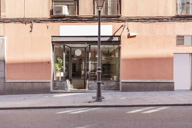 A small commercial premises at street level with a black metal and glass facade