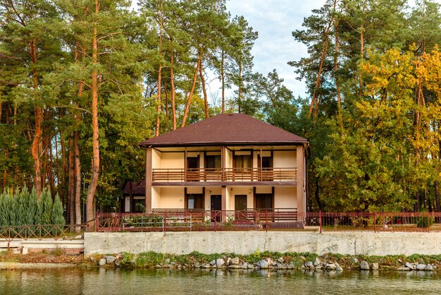 A small complex hotel in the forest consisting of several houses in pines on the banks of the river. Tourist holiday