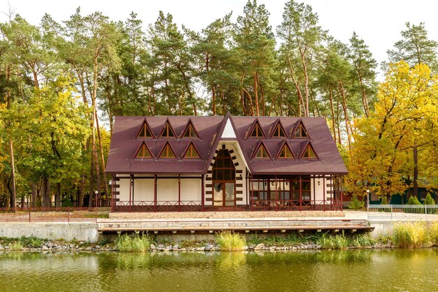 A small complex hotel in the forest consisting of several houses in pines on the banks of the river