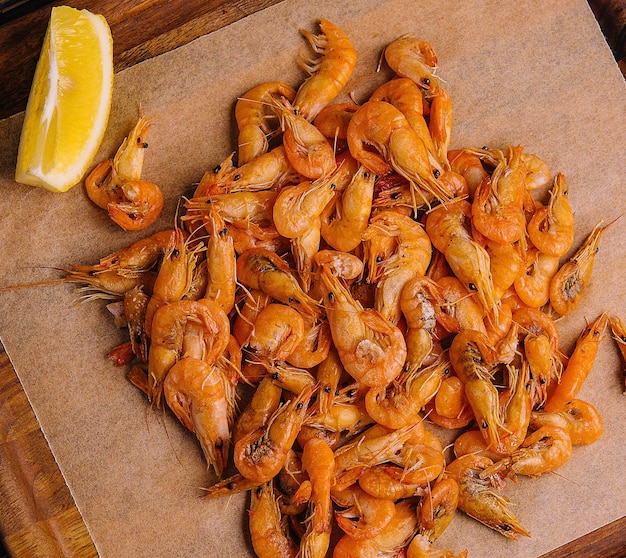 Small cooked shrimp on wooden tray