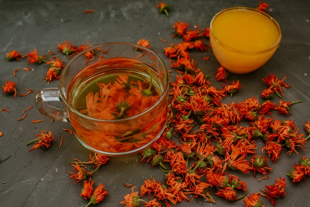 A small cup with yellow liquid honey