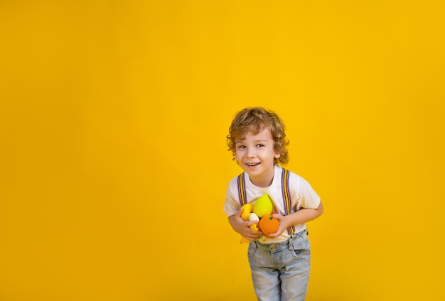 a small curlyhaired boy on a yellow background