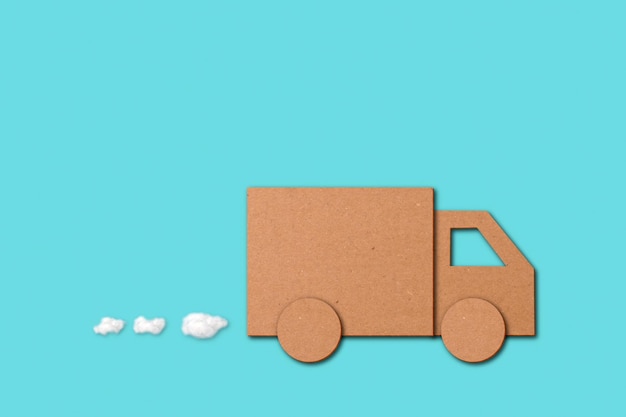 small cutout of a van over a blue background in a concept of shopping business deliveries and orders