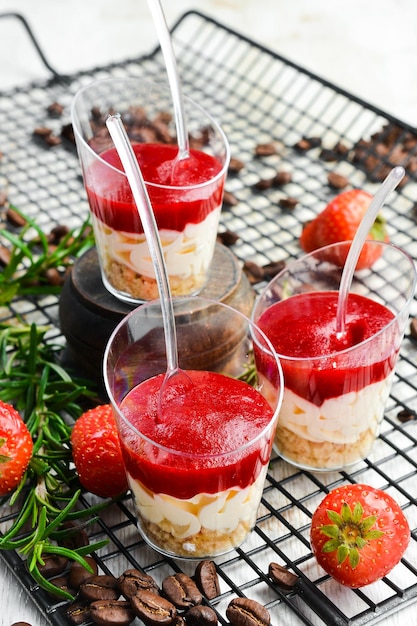 Small dessert: strawberries, cream and nuts in plastic cups. Top view. Sweet bar.