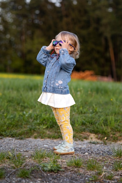 A small fashionista tries on sunglasses