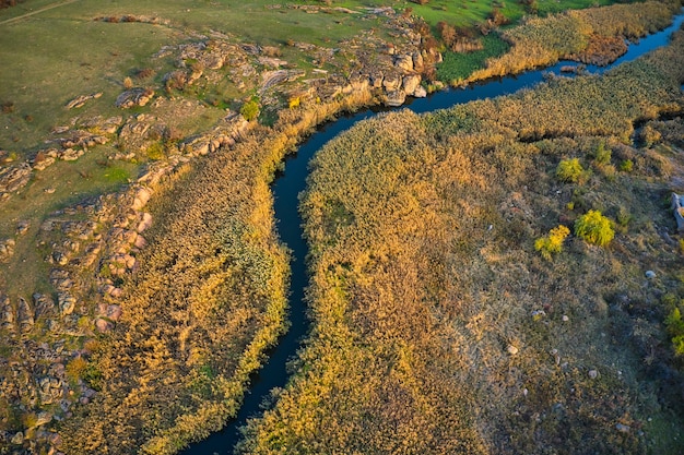 A small fast stream Kamenka in the wilderness in the evening light in Ukraine