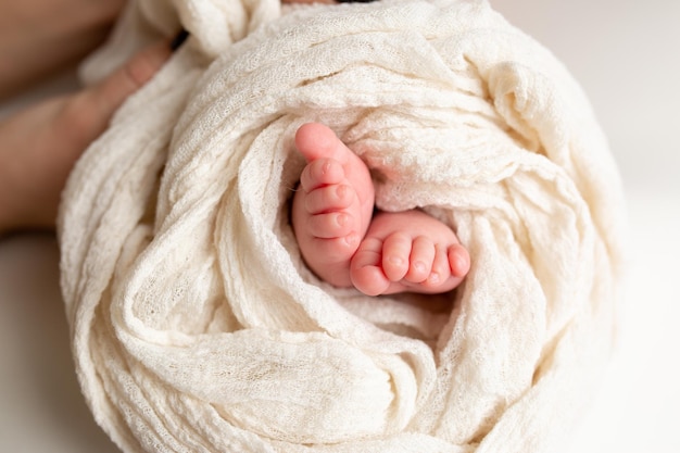 small feet of a newborn baby on a white background