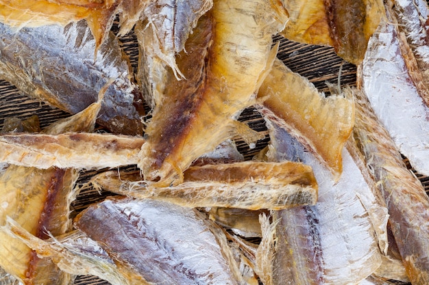 Small fish gutted and dried with salt, dried and butchered small fish on a wooden table