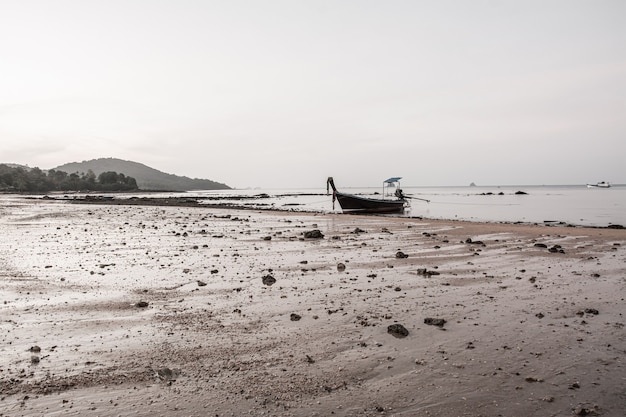 Small fishing boat on the beach in the evening