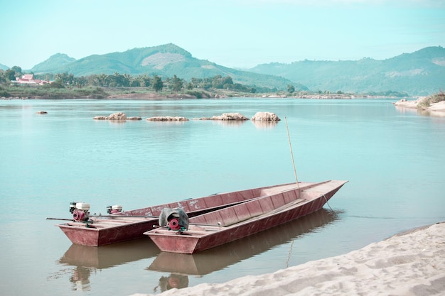 Small fishing boat with fishing net and equipment A longtailed boat stranded on the beach for repairs at HuayLa Beach