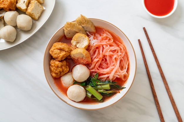 small flat rice noodles with fish balls and shrimp balls in pink soup, Yen Ta Four or Yen Ta Fo - Asian food style