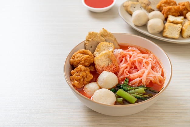 Small flat rice noodles with fish balls and shrimp balls in pink soup Yen Ta Four or Yen Ta Fo