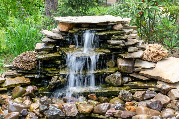 A small fountain made of stones made by man