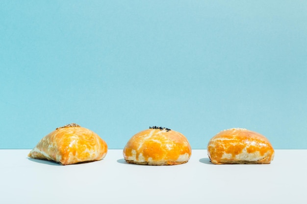 Small fried pies with meat samsa on blue background high quality photo