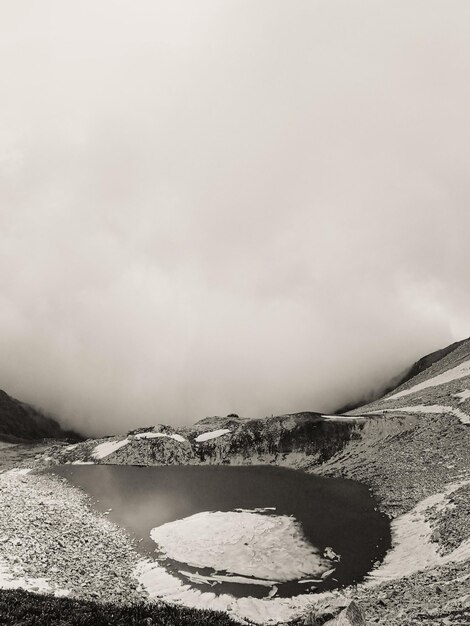 Photo small frozen lake on the top of a rocky mountain