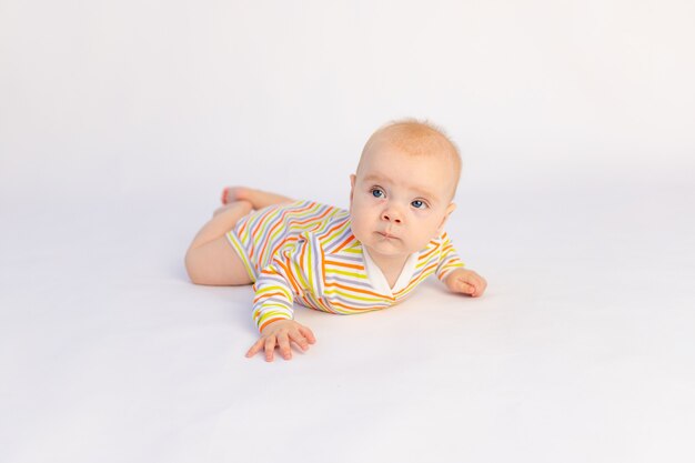 Small funny baby girl on the bed