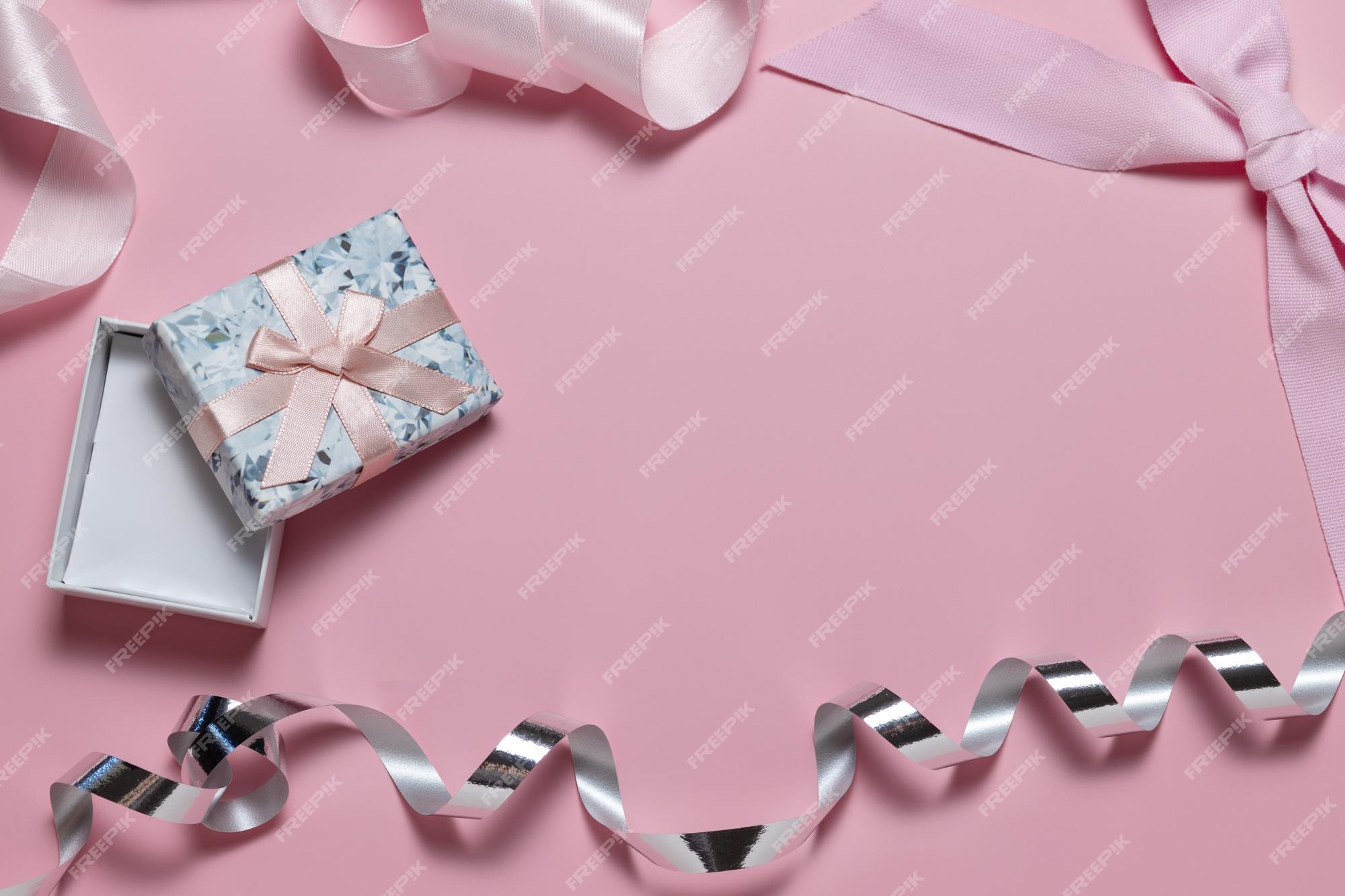 Premium Photo  Small gift box with bow pink and silver ribbon for gift  wrapping on pink background