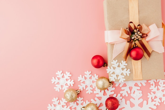 small gift wrapped with ribbon on pink background